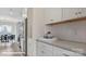 Modern kitchen with white cabinets, stainless steel appliances, and quartz countertops, open to dining area at 122 Asmodean Ln, Troutman, NC 28166