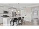 Open kitchen boasts white cabinetry, an island with seating, and hardwood flooring at 122 Asmodean Ln, Troutman, NC 28166