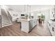 Open concept kitchen with stainless appliances, island with bar seating, adjacent to the living area at 122 Asmodean Ln, Troutman, NC 28166