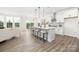 Open-concept living room and kitchen with bright, neutral tones and modern appliances at 122 Asmodean Ln, Troutman, NC 28166