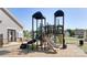 This community playground features slides and play structures adjacent to modern homes, offering children a fun outdoor area at 122 Asmodean Ln, Troutman, NC 28166