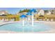 The community splash pad features several mushroom fountains and is located near lounge seating and umbrellas at 122 Asmodean Ln, Troutman, NC 28166
