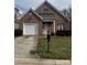Charming brick home featuring a well-maintained lawn, attached garage, and inviting front entrance at 1229 Mcgill Pond Ln, Rock Hill, SC 29732