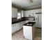 Modern kitchen with white cabinets, black countertops, and stainless steel appliances at 1229 Mcgill Pond Ln, Rock Hill, SC 29732