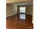 Open living room with ceiling fan, hardwood floors, and a neutral color palette at 1229 Mcgill Pond Ln, Rock Hill, SC 29732