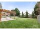 Expansive backyard with a stamped concrete patio and pergola providing an excellent space for entertaining at 12430 Kemerton Ln # 17, Huntersville, NC 28078