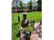 Cozy backyard featuring a clay fireplace, potted flowers and a lush lawn at 12430 Kemerton Ln # 17, Huntersville, NC 28078