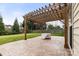 Stamped concrete patio featuring a wooden pergola, perfect for outdoor entertaining at 12430 Kemerton Ln # 17, Huntersville, NC 28078