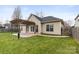 Home exterior with a stamped concrete patio with pergola and expansive grassy backyard at 12430 Kemerton Ln # 17, Huntersville, NC 28078