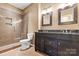 Bathroom featuring double vanity, framed mirrors, glass enclosed shower, and neutral tile flooring at 12430 Kemerton Ln # 17, Huntersville, NC 28078