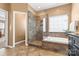 Gorgeous bathroom featuring a glass enclosed shower and soaking tub at 12430 Kemerton Ln # 17, Huntersville, NC 28078