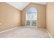 Empty bedroom featuring a large arched window providing lots of natural light and neutral carpet and walls at 12430 Kemerton Ln # 17, Huntersville, NC 28078