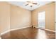 Empty bedroom featuring hardwood floors, neutral walls, a ceiling fan and a window for natural light at 12430 Kemerton Ln # 17, Huntersville, NC 28078