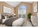 Comfortable bedroom with ample natural light from large arched window, neutral walls, and stylish decor at 12430 Kemerton Ln # 17, Huntersville, NC 28078
