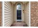 Front door with stone porch, sidelights, and house number at 12430 Kemerton Ln # 17, Huntersville, NC 28078