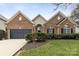 Charming brick home with a well-manicured lawn and a two-car garage at 12430 Kemerton Ln # 17, Huntersville, NC 28078