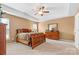Cozy main bedroom with a ceiling fan, tray ceiling and carpet flooring at 12430 Kemerton Ln # 17, Huntersville, NC 28078