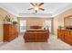 Comfortable main bedroom features a ceiling fan, carpet, and ample natural light at 12430 Kemerton Ln # 17, Huntersville, NC 28078