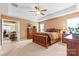 Comfortable main bedroom is complete with a ceiling fan and plush carpeting at 12430 Kemerton Ln # 17, Huntersville, NC 28078