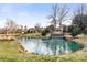 Scenic community pond featuring waterfall features and lush landscaping at 12430 Kemerton Ln # 17, Huntersville, NC 28078