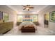 A beautiful main bedroom with a tray ceiling, an ensuite bath, and bright windows at 126 Asmodean Ln, Troutman, NC 28166