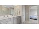 Bathroom featuring a double vanity with modern fixtures and a view into the bedroom at 128 Asmodean Ln, Troutman, NC 28166