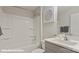 Well-lit bathroom with a clean white tub-shower combo, vanity, and modern sink at 128 Asmodean Ln, Troutman, NC 28166