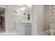 Bright bathroom featuring double sinks, a large mirror, and stylish decor at 128 Asmodean Ln, Troutman, NC 28166
