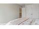 Serene bedroom featuring neutral walls, bed with floral pattern, and a closet at 128 Asmodean Ln, Troutman, NC 28166
