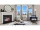 Bright living room with fireplace, large windows and modern furniture, wood flooring at 128 Asmodean Ln, Troutman, NC 28166