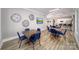 Community lounge featuring wood floors, modern artwork, and table seating at 128 Asmodean Ln, Troutman, NC 28166