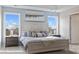 Serene main bedroom featuring large windows, a neutral color palette, and ample natural light at 128 Asmodean Ln, Troutman, NC 28166