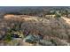 The aerial view captures a verdant landscape dotted with homes among mature trees at 13124 Lemmond Dr, Matthews, NC 28105