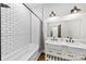 Bright bathroom featuring double sinks, subway tile, and modern fixtures at 13124 Lemmond Dr, Matthews, NC 28105