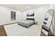 Minimalist bedroom with a gray upholstered bed frame, mountain art pieces, dark window blinds, and neutral rug at 13124 Lemmond Dr, Matthews, NC 28105