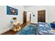 Bright bedroom features a solar system poster, a blue rug, and hardwood floors at 13124 Lemmond Dr, Matthews, NC 28105