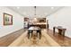 Spacious dining room features hardwood floors, white walls, a large rug, and a modern chandelier at 13124 Lemmond Dr, Matthews, NC 28105