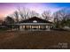 Charming home with a wide porch and a sunset sky at 13124 Lemmond Dr, Matthews, NC 28105