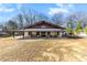 Sprawling home with expansive porch, offering a welcoming entrance and ample outdoor space at 13124 Lemmond Dr, Matthews, NC 28105