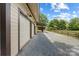 Spacious three-car garage with a gravel driveway, set in a lush landscape at 13124 Lemmond Dr, Matthews, NC 28105