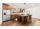 Kitchen island with barstool seating and stainless steel appliances at 13124 Lemmond Dr, Matthews, NC 28105