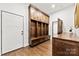 Mudroom with custom wood storage lockers, bench, drawers, and hardwood floors throughout at 13124 Lemmond Dr, Matthews, NC 28105