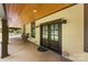 Welcoming covered porch featuring double doors and stylish outdoor decor at 13124 Lemmond Dr, Matthews, NC 28105