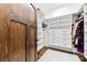 Neatly organized walk-in closet features custom shelving and drawers, plus hardwood floors at 13124 Lemmond Dr, Matthews, NC 28105