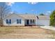 Charming single-story home with blue shutters, front porch, and attached two car garage at 1345 Beagle Run, Salisbury, NC 28146