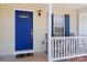 Inviting front porch featuring blue door, chairs, and a welcoming mat at 1345 Beagle Run, Salisbury, NC 28146
