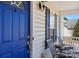 Charming front porch with seating area and a vibrant blue entry door at 1345 Beagle Run, Salisbury, NC 28146