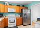 Kitchen featuring stainless steel appliances, warm oak cabinets, and neutral countertops at 1345 Beagle Run, Salisbury, NC 28146