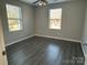 Inviting bedroom with wood floors and natural light from two windows at 1404 Lineberger Ave, Gastonia, NC 28052