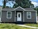 Charming single-story home featuring gray siding and a well-manicured front lawn at 1404 Lineberger Ave, Gastonia, NC 28052